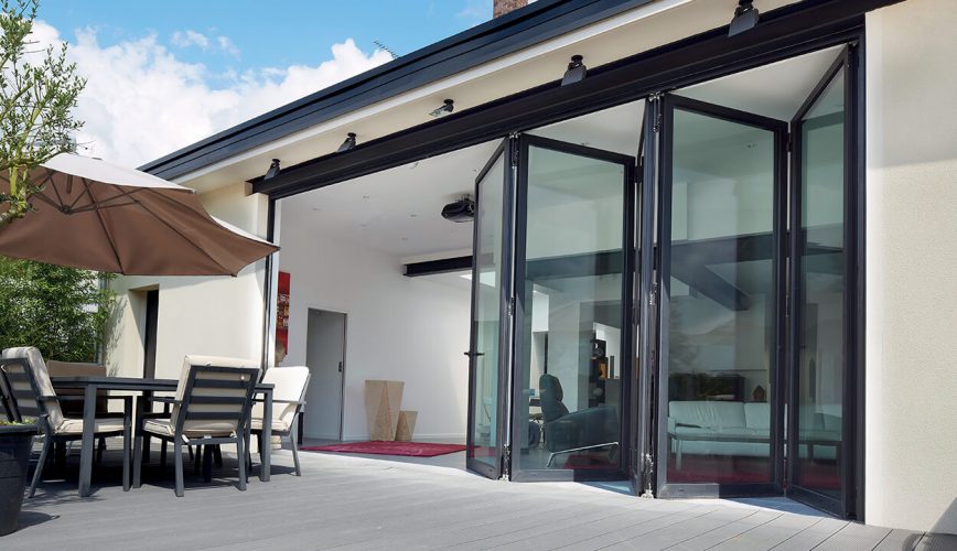An open black aluminium bifold door