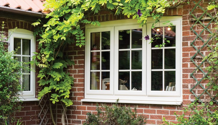 White uPVC casement windows with astragal bars